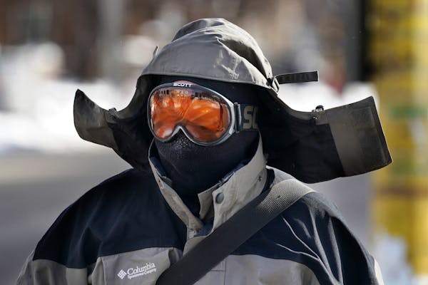 Chris Zabinski, a catering chef at the University of Minnesota, wore ski goggles and a face mask in addition to his coat as he walked to catch a bus T
