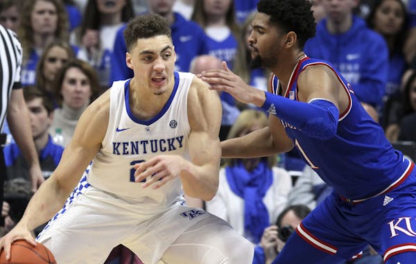 Neither of these guys — Kentucky forward Reid Travis (22) and Kansas forward Dedric Lawson — started their college careers with those teams. Travi