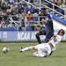 Maryland's Chase Gasper,slide-tackled Akron's Adbi Mohamed, left, during the 2018 NCAA College Cup soccer match Dec. 9. Gasper was selected by Minneso