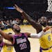 Timberwolves guard Josh Okogie, left, shoots as Los Angeles Lakers guard Lance Stephenson defends during the first half