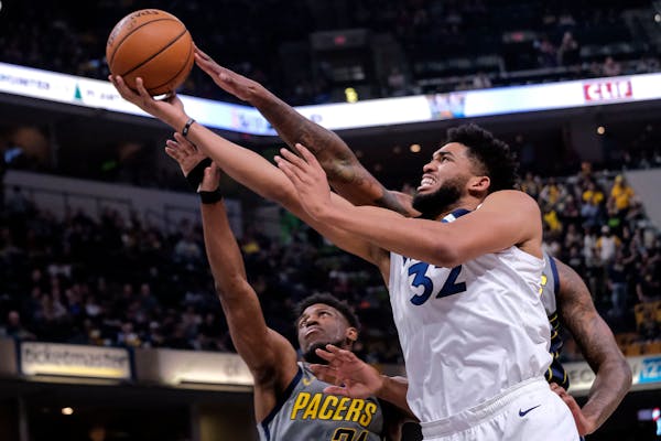 Timberwolves center Karl-Anthony Towns shoots in front of Pacers forward Thaddeus Young during the first half