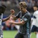 Minnesota United’s Carlos Darwin Quintero (25) celebrates his goal with Rasmus Schuller during the first half against Vancouver Whitecaps on March 2