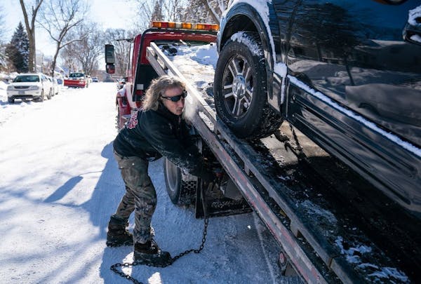 Kerry Brendmoen of Corky's Towing removed a vehicle that was parked on the wrong side of a snow emergency route in south Minneapolis earlier this mont