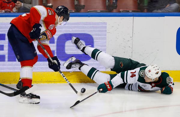 Panthers center Frank Vatrano tried to control the puck next to a fallen Joel Eriksson Ek during the third period of the Wild's 6-2 loss at Florida.