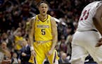 Minnesota's Amir Coffey (5) reacts after a basket against Louisville during the second half of a first round men's college basketball game in the NCAA