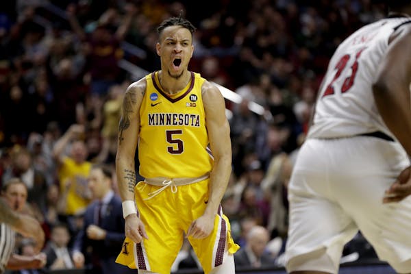Minnesota's Amir Coffey (5) reacts after a basket against Louisville during the second half of a first round men's college basketball game in the NCAA