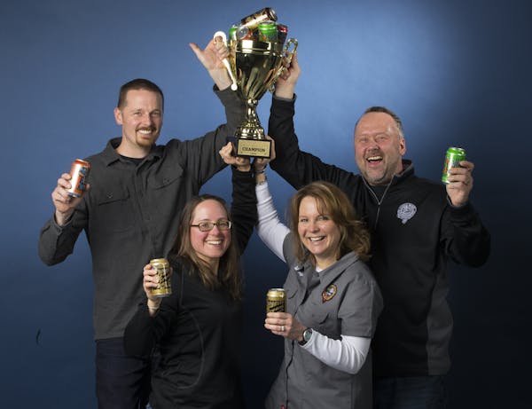 Castle Danger Brewery owners, from left, Clint MacFarlane, Jamie MacFarlane, Mandy Larson and Lon Larson hoisted the trophy after their surprise victo