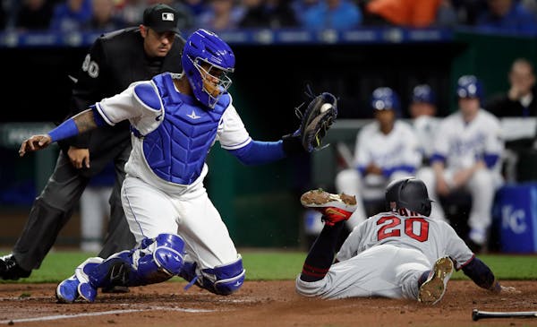The Twins' Eddie Rosario dove home and beat the tag by Royals catcher Martin Maldonado to score from first base in the fourth inning Tuesday.