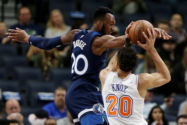 The Knicks' Kevin Knox tried to shoot over the Timberwolves' Josh Okogie in the first half of Minnesota's 103-92 victory at Target Center on Sunday.