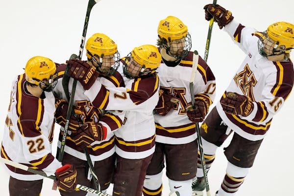 Gophers players celebrated with forward Brent Gates Jr. (10) after a goal against Wisconsin in January.