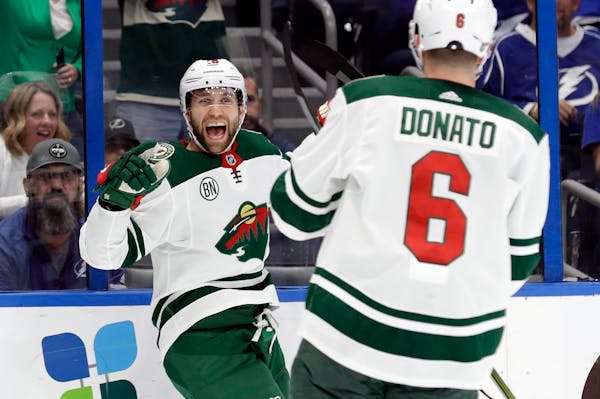 Minnesota Wild left wing Jason Zucker (16) celebrates his goal against the Tampa Bay Lightning with center Ryan Donato (16) during the first period of