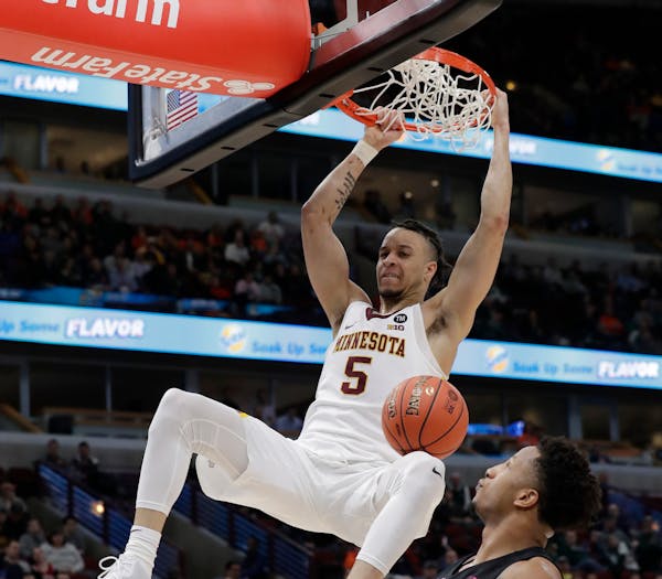 Amir Coffey dunks over Penn State's Lamar Stevens during the second half, one in which Coffey willed the Gophers to overtime and a victory