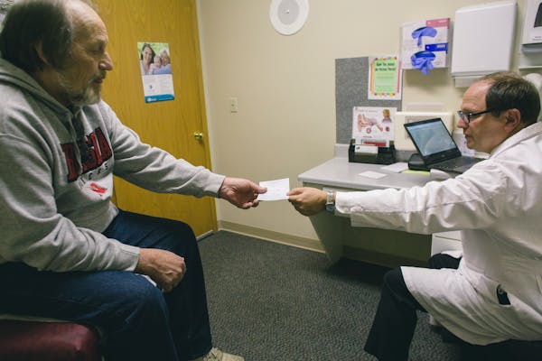 A patient received a prescription from his doctor as he combats chronic pain.