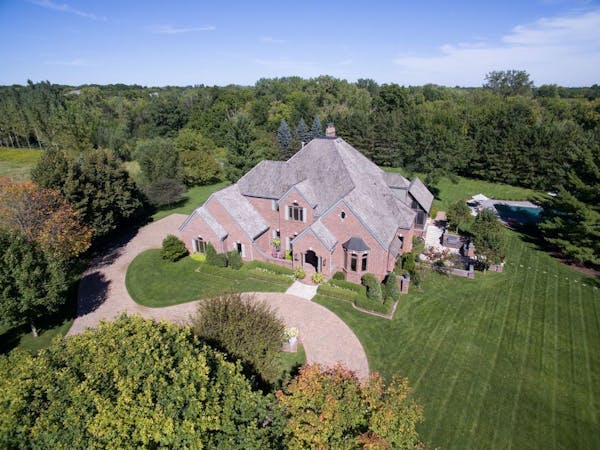 Aerial view of a luxurious home and grounds now on the market in Orono.