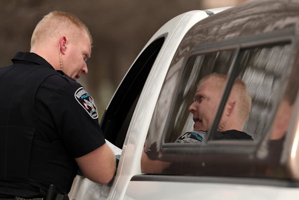 Officer Chris Walswick with the Burnsville Police Department talked with a driver during a traffic stop related to a distracted-driving patrol. Office