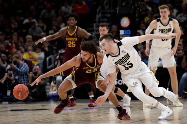 Gophers guard Gabe Kalscheur went for a loose ball with Purdue’s Sasha Stefanovic on Friday, when Kalscheur shut down Boilermakers star Carsen Edwar