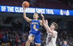 Waseca’s Malik Willingham went up for two despite defensive efforts from Academy of Holy Angels’ Thor Holien.
