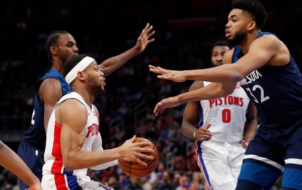 Timberwolves center Karl-Anthony Towns closes in on Pistons guard Bruce Brown during the first half