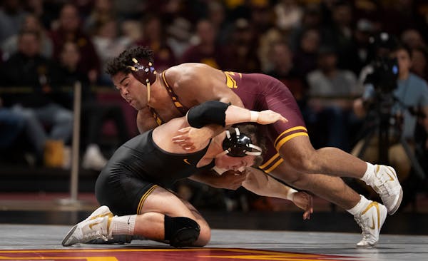 Gophers heavyweight Gable Steveson (shown in a January match vs. Iowa) advanced to Sunday's finals.