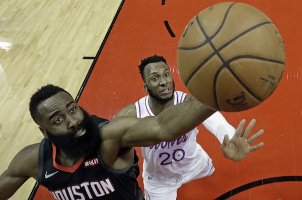 Rockets star James Harden shot as Timberwolves rookie Josh Okogie defended in the first half Sunday.