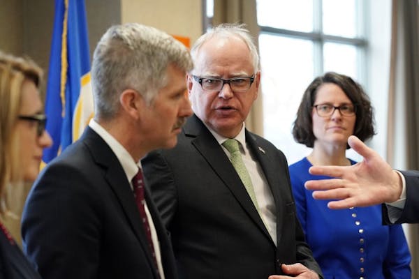 Gov. Tim Walz looked to Department of Human Services Commissioner Tony Lourey during a news conference and health care roundtable earlier in March.