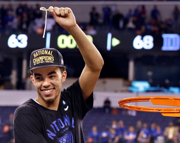 Tyus Jones cut down the net after Duke's 68-63 victory over Wisconsin in the 2015 Final Four championship game