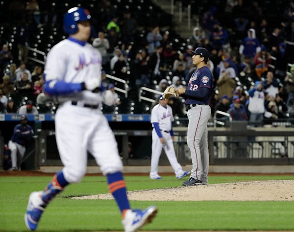 Twins reliever Andrew Vasquez stood on the mound as the Mets' Brandon Nimmo, left, reached first base after being hit by a pitch Wednesday to force in