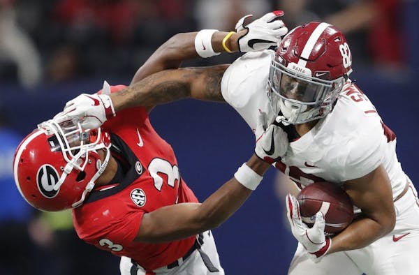Alabama tight end Irv Smith Jr. (82), right, hits Georgia defensive back Tyson Campbell (3) in the helmet during the first half of the Southeastern Co