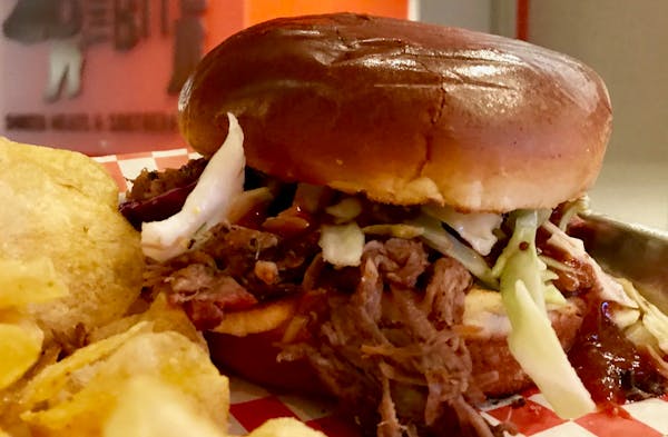 Bark and the Bite’s slaw-topped pulled pork sandwich.