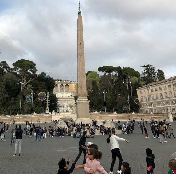 Children chased bubbles in Piazza del Popolo in Rome.