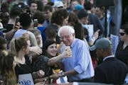Sen. Bernie Sanders (I-Vt.), a candi­date for the Democratic presidenti­al nomin­ation, takes a photo with a fan after speaking at a rally in Pitts
