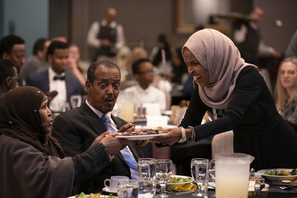 U.S. Rep. Ilhan Omar offered a plate of dates to others at her table as iftar commenced. At center is her father, Nur Omar Mohamed.