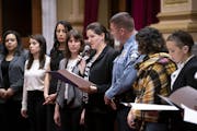Council Member Linea Palmisano (with microphone) stood Wednesday at the front of the City Hall Chambers with justice officials, survivors and other co