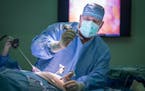 Dr. Jared Slater prepared a patient for robotic gall bladder surgery at RC Hospital and Clinics in Olivia, Minn. The hospital gambled that investing i