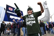 Tristan Dieterle, 10, from Michigan’s Upper Peninsula, showed his excitement with meeting Michigan State’s Sparty as he waited with his aunt, cous