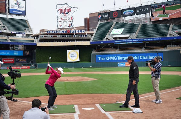 LPGA Tour star Stacy Lewis and PGA Tour star Phil Mickelson took turns Monday re-enacting famous hits from Twins history from home plate at Target Fie