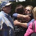 Members of the Chabad synagogue hugged as they gather near the Altman Family Chabad Community Center, Saturday, April 27, 2019 in Poway, Calif.