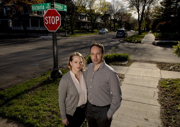 Christina Anderson-Taghioff and Simon Taghioff stood at the intersection of Victoria Street and Osceola Avenue in front of their home in St. Paul.