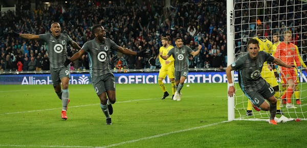 Minnesota United midfielder Ethan Finlay (13, right) celebrated after scoring a goal in the second half as midfielder Kevin Molino (7) and forward Ang