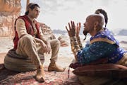 Mena Massoud plays Aladdin and Will Smith is the Genie in the live-action “Aladdin.”