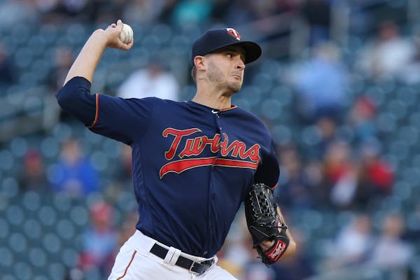 Twins pitcher Jake Odorizzi throws to a Detroit batter during the first inning
