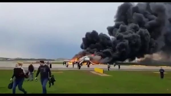 Russian plane lands in flames in Moscow
