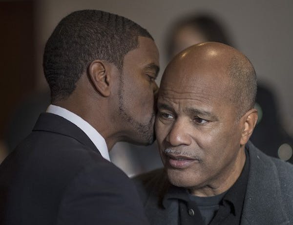 St. Paul Mayor Melvin Carter kissed his father, Melvin Carter Jr., at a prayer service. The elder Carter founded SOS.