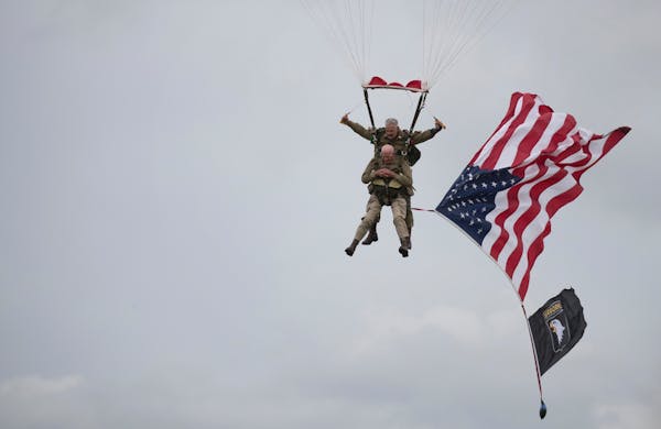 U.S. World War II D-Day veteran Tom Rice, from Coronado, CA, parachutes in a tandem jump into a field in Carentan, Normandy, France, Wednesday, June 5
