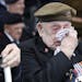 A veteran wipes his eyes during a ceremony to mark the 75th anniversary of D-Day, Wednesday, June 5, 2019, in Portsmouth, England.