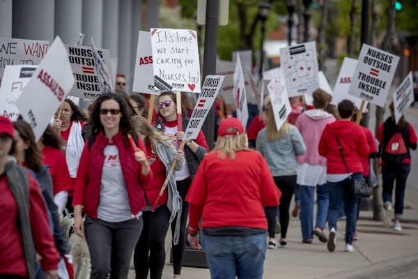 Nurses and their supporters picketed on the sidewalk outside Children's St. Paul and United Hospital on May 23, 2019, in St. Paul.
