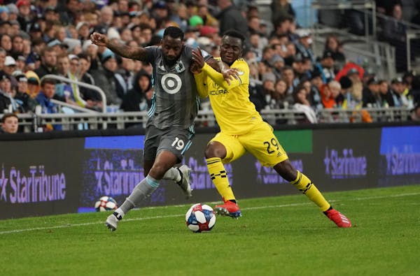 Minnesota United defender Romain Metanire, left, battled the Columbus Crew’s David Accam in the first half of a May 18 game at Allianz Field.