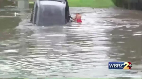 Firefighters swim through flash flood, save driver