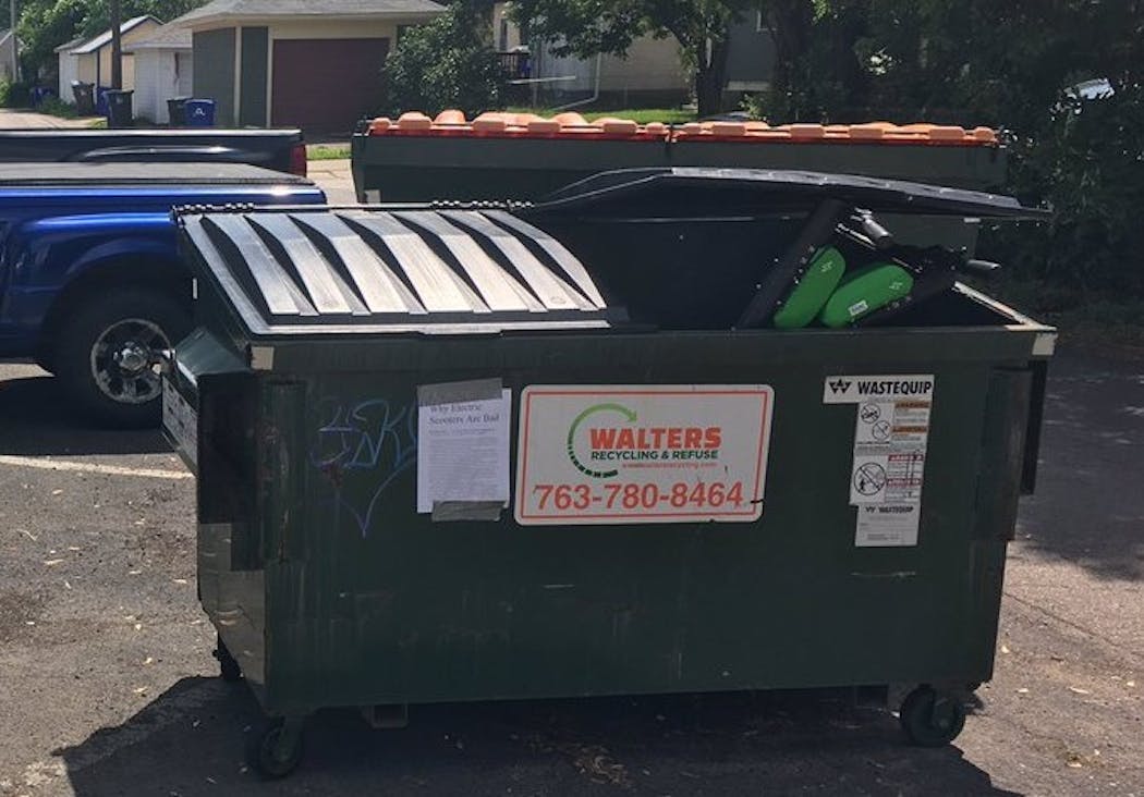 Tom Basgen said he witnessed a man throwing Lime electric scooters into this dumpster behind Groundswell in St. Paul last month.