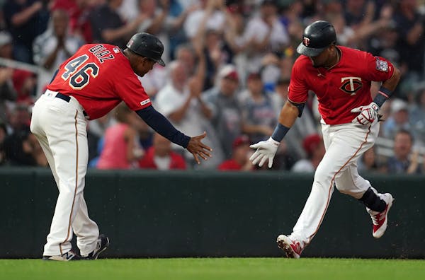 Twins third baseman Luis Arraez celebrated with third base coach Tony Diaz after hitting his second major league home run, the first of four Twins hom